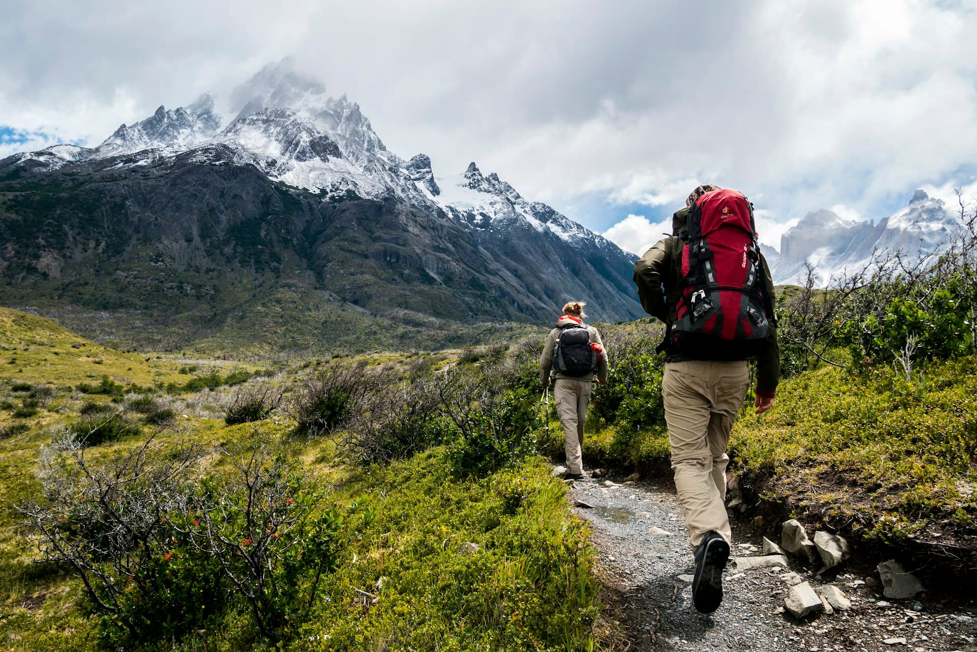 Group of hikers trekking through snow-covered mountain wilderness terrain, representing NOLS expedition-based outdoor leadership education
