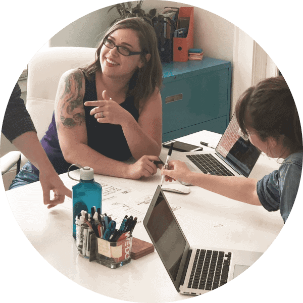 Coworkers Working At Whiteboard Table